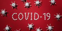 Covid-19 på rød baggrund samt virus